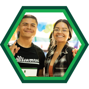 Two students smiling with Stingers Up hand gestures